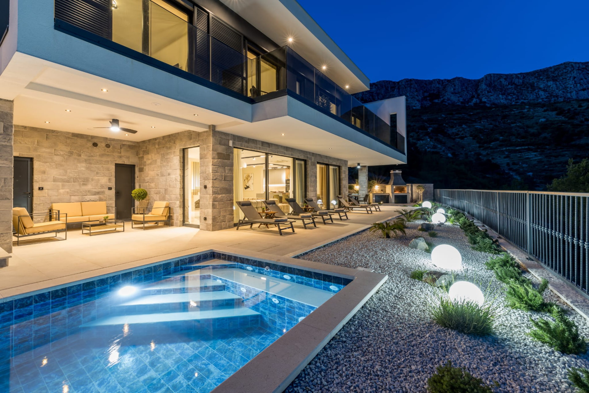 Villa M&D pool and facade illuminated at dusk